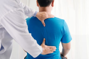 Man getting his back examined