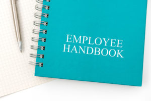 employee handbook with pen