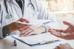 doctor providing a note to a patient