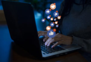 Man on social media on laptop